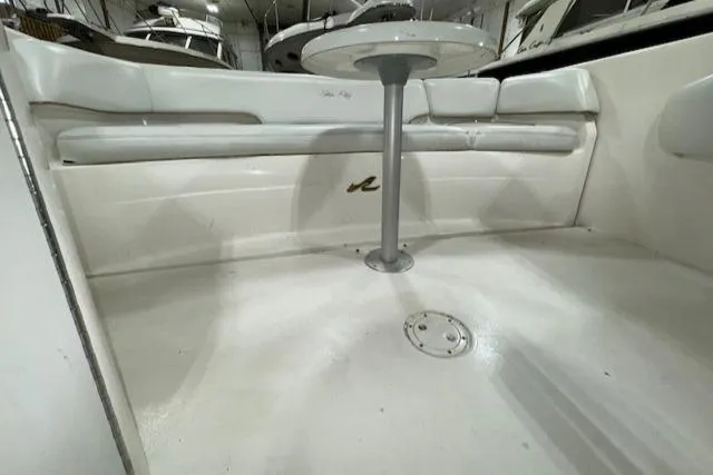 Slide: The Image of 1997 Sea Ray 280 boat interior with white seating and table. - 13