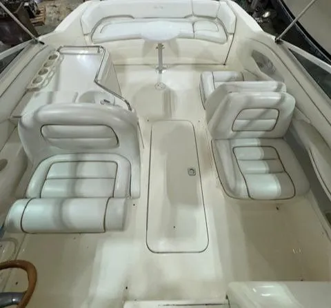 Slide: The Image of 1997 Sea Ray 280 boat interior with white leather seating and a small table. - 16