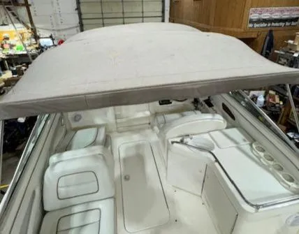 Slide: The Image of 1997 Sea Ray 280 boat interior with canopy, white seating, and storage compartments. - 17