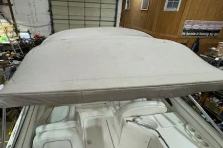 Slide: The Image of 1997 Sea Ray 280 boat interior with canopy in a storage facility. - 18