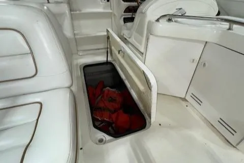 Slide: The Image of 1997 Sea Ray 280 boat interior with open storage compartment. - 2