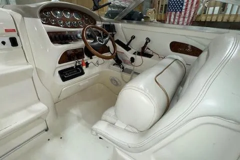 Slide: The Image of 1997 Sea Ray 280 boat interior with white leather seats and control panel. - 22