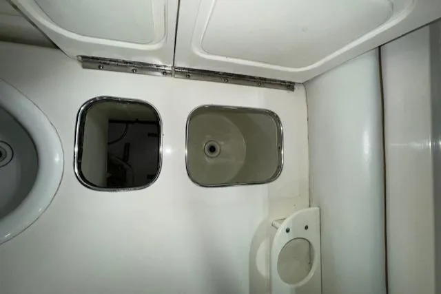 Slide: The Image of 1997 Sea Ray 280 boat bathroom sink and storage compartments. - 23
