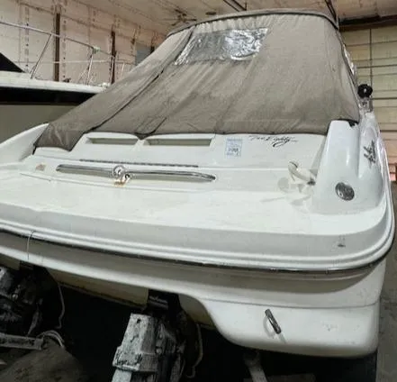 Slide: The Image of 1997 Sea Ray 280 boat in storage with protective cover. - 27