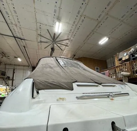 Slide: The Image of 1997 Sea Ray 280 boat stored indoors with a protective cover. - 29