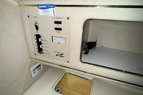 Slide: The Image of Control panel and storage area inside a 1997 Sea Ray 280 boat. - 42