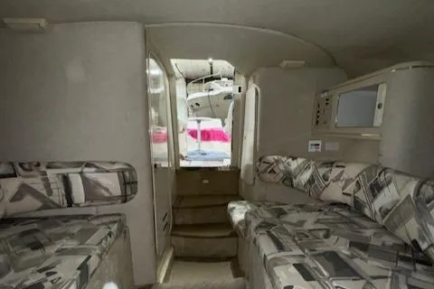 Slide: The Image of 1997 Sea Ray 280 boat interior with patterned seating and compact design. - 44