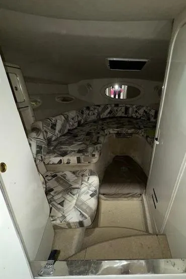 Slide: The Image of 1997 Sea Ray 280 cabin interior with patterned seating and compact design. - 46