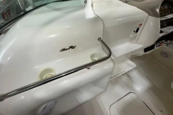 Slide: The Image of 1997 Sea Ray 280 boat interior with cup holders and dashboard. - 5