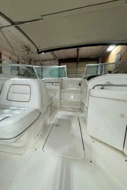 Slide: The Image of 1997 Sea Ray 280 boat interior with white seating and helm station. - 7