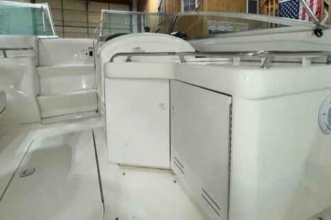 Slide: The Image of 1997 Sea Ray 280 boat interior with white cabinetry and seating. - 8