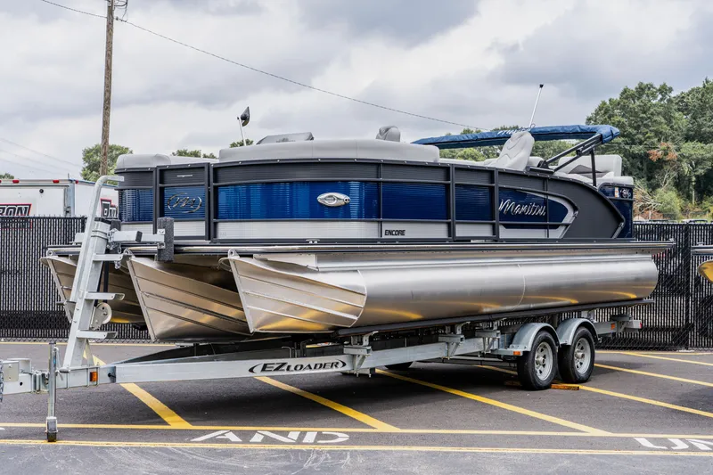 The Image of 2022 Manitou 23 Encore pontoon boat on EZ Loader trailer. - 1