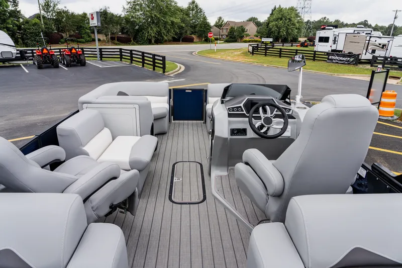 Slide: The Image of 2022 Manitou 23 Encore pontoon boat interior with gray seating and modern helm. - 8