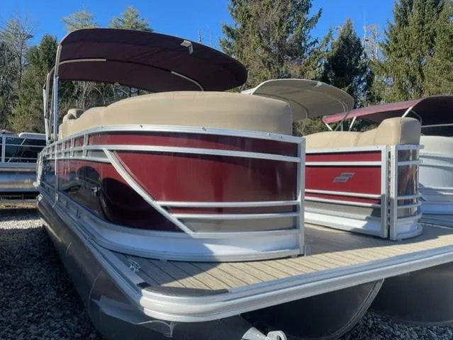 Slide: The Image of 2023 Starcraft CX 25 RL Tritoon with 300 Mercury DTS, maroon and beige, docked outdoors. - 1
