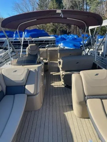 Slide: The Image of 2023 Starcraft CX 25 RL Tritoon boat interior with seating and canopy. - 3