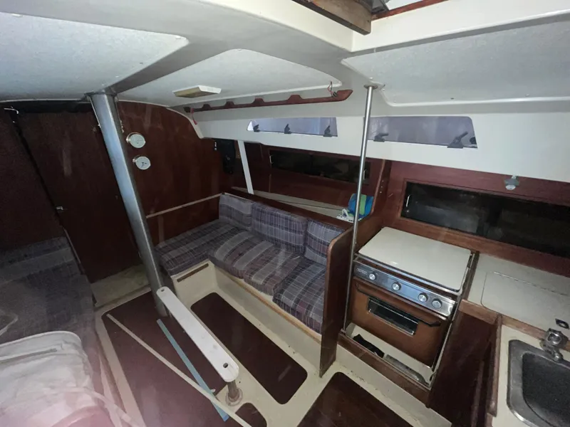 Slide: The Image of Interior of a 1980 C&C 34 sailboat with seating and kitchen area. - 4