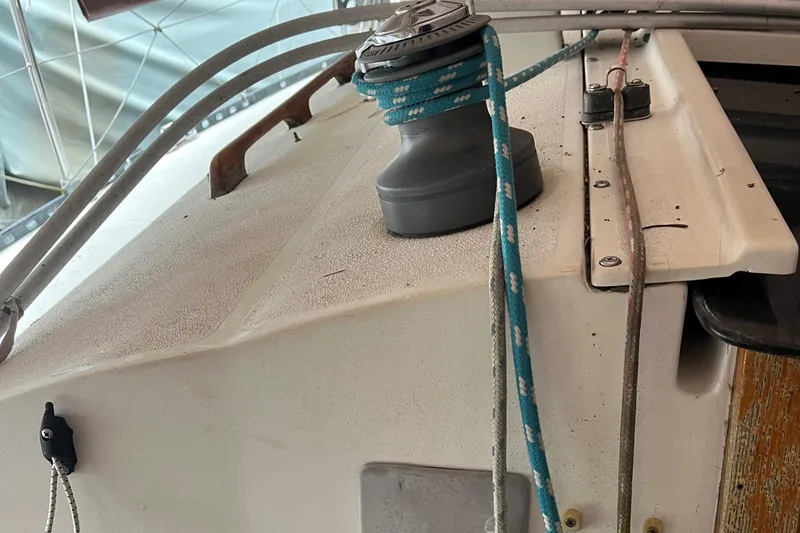 Slide: The Image of 1980 C&C 34 sailboat deck with winch and ropes. - 9