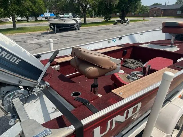 Slide: The Image of 1988 Lund Rebel 16 Tiller boat with Evinrude motor, red interior, and brown seats. - 2
