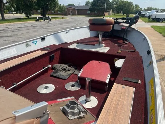 Slide: The Image of 1988 Lund Rebel 16 Tiller boat interior with red carpet and seating. - 3