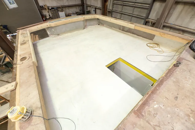 Slide: The Image of Custom Carolina 63 2024 boat under construction in a workshop. - 16