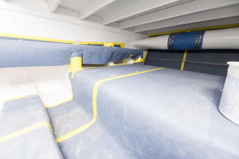 Slide: The Image of Interior construction of 2024 Custom Carolina 63 boat with protective coverings. - 19