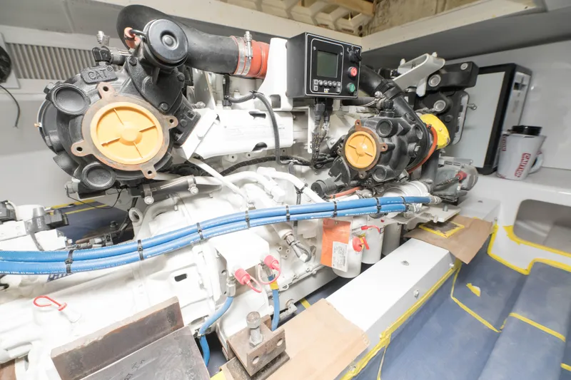 Slide: The Image of Engine room of a 2024 Custom Carolina 63 boat with visible machinery and components. - 21