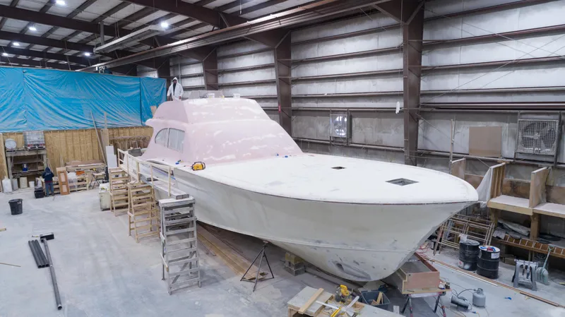 Slide: The Image of 2024 Custom Carolina 63 yacht under construction in a workshop. - 23