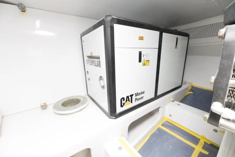 Slide: The Image of CAT Marine Power generator in the engine room of a 2024 Custom Carolina 63 boat. - 26