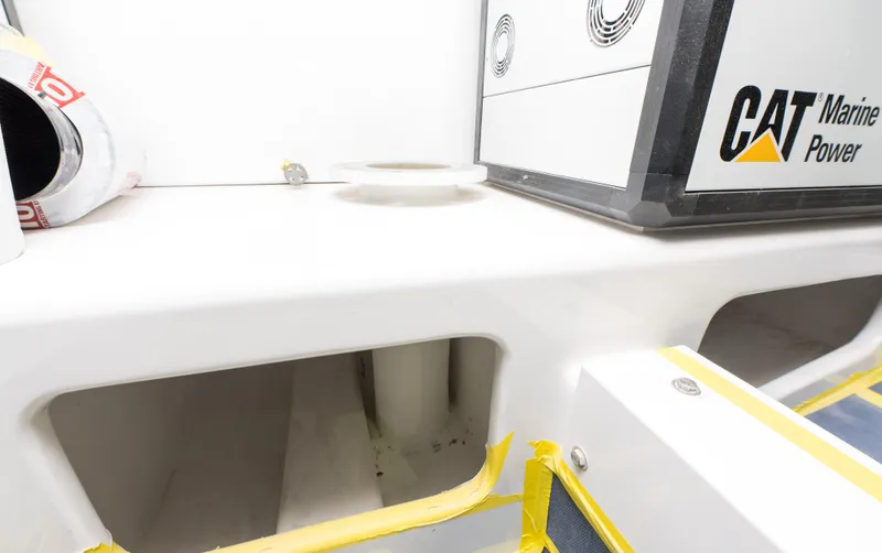 Slide: The Image of 2024 Custom Carolina 63 boat engine compartment with CAT Marine Power system. - 27
