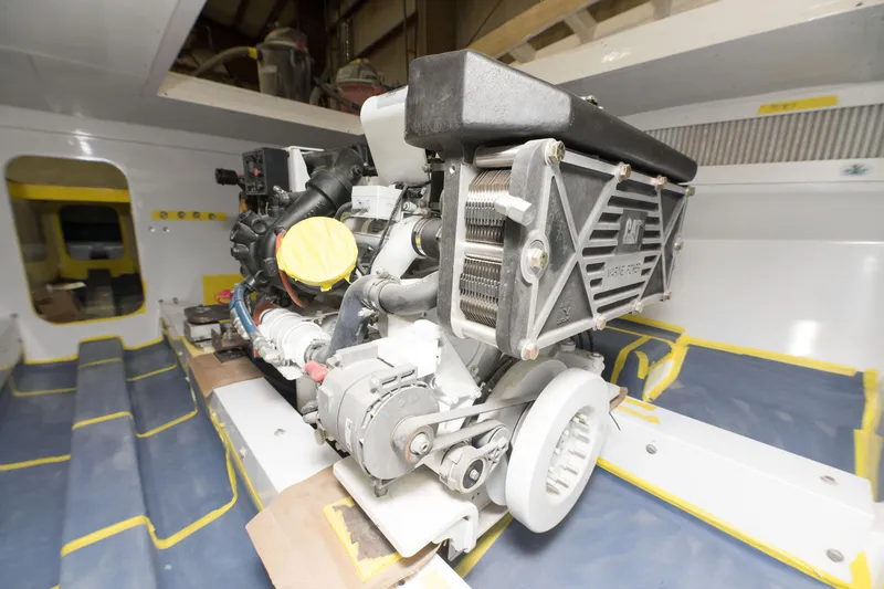Slide: The Image of Engine room of a 2024 Custom Carolina 63 boat with visible machinery. - 28