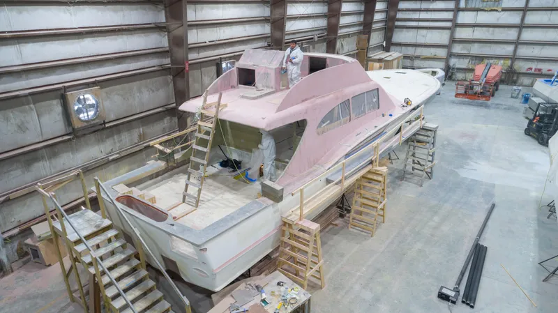 Slide: The Image of 2024 Custom Carolina 63 yacht under construction in a large indoor facility. - 3