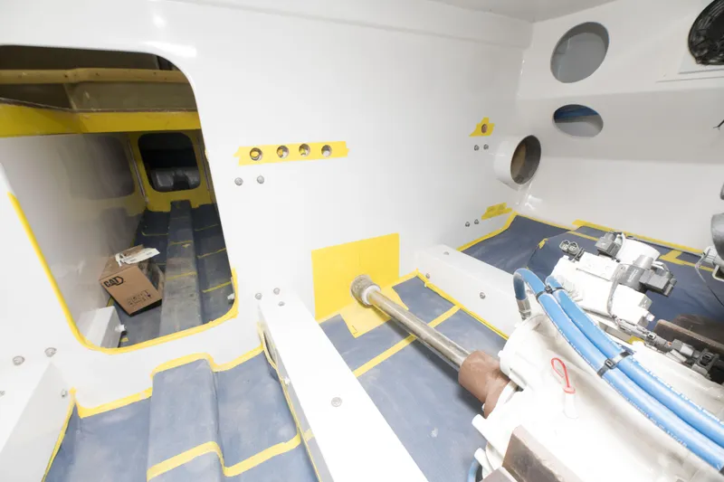 Slide: The Image of Interior of 2024 Custom Carolina 63 boat under construction, showing engine room and components. - 33