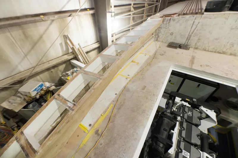 Slide: The Image of 2024 Custom Carolina 63 boat under construction in a workshop. - 35