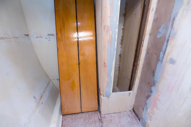 Slide: The Image of Interior construction of 2024 Custom Carolina 63 boat with unfinished walls and wooden panel. - 38