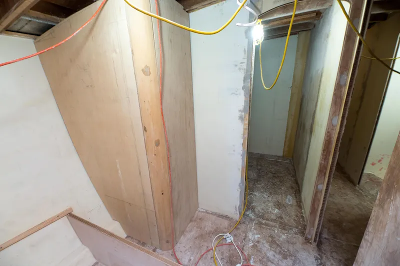 Slide: The Image of Custom Carolina 63 2024 interior under construction with exposed wiring and unfinished walls. - 40