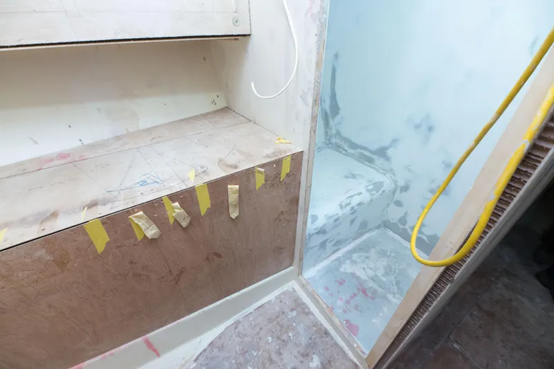 Slide: The Image of 2024 Custom Carolina 63 interior under construction, showcasing unfinished woodwork and taped sections. - 41