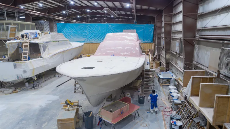 Slide: The Image of 2024 Custom Carolina 63 yacht under construction in a workshop. - 7