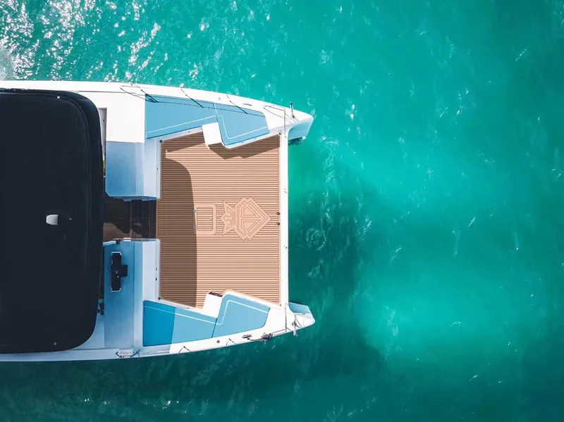 Slide: The Image of 2024 Diamond Yachts P55 Power Catamaran on turquoise water. - 2