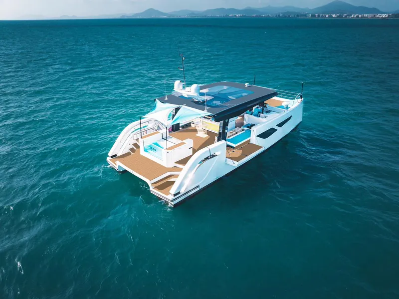 Slide: The Image of 2024 Diamond Yachts P55 Power Catamaran cruising on open water. - 3