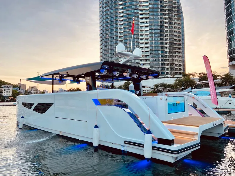 Slide: The Image of 2024 Diamond Yachts P55 Power Catamaran docked with cityscape background. - 4