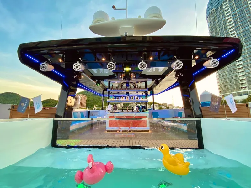 Slide: The Image of 2024 Catamaran Diamond Yachts P55 Power Catamaran with pool and cityscape backdrop. - 5