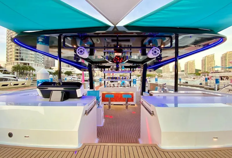 Slide: The Image of 2024 Diamond Yachts P55 Power Catamaran with modern deck and vibrant lighting. - 6