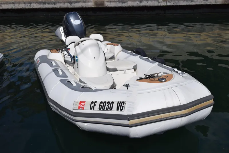 Slide: The Image of 2017 Avon Seasport 400DL inflatable boat with outboard motor, docked in calm water. - 3