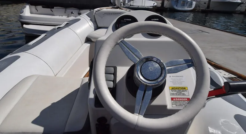 Slide: The Image of 2017 Avon Seasport 400DL boat steering wheel and dashboard at marina. - 6