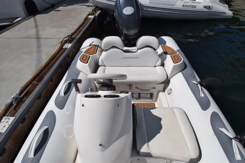 Slide: The Image of 2017 Avon Seasport 400DL boat interior with seating and console, docked at marina. - 7