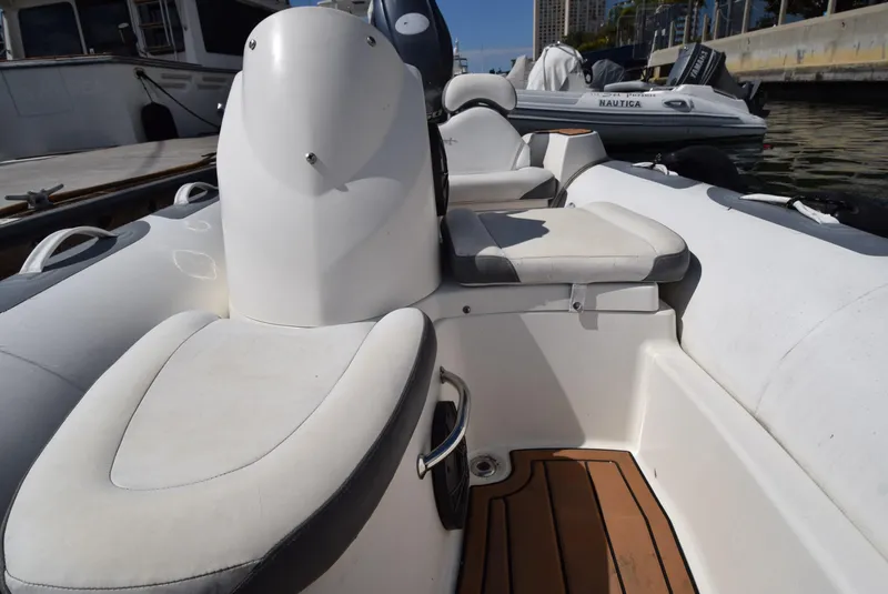 Slide: The Image of 2017 Avon Seasport 400DL boat interior with white seating and wooden flooring. - 8