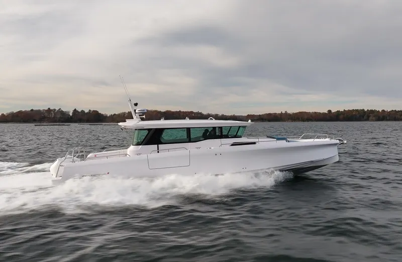 Slide: The Image of 2024 Axopar 45 boat cruising on open water. - 1