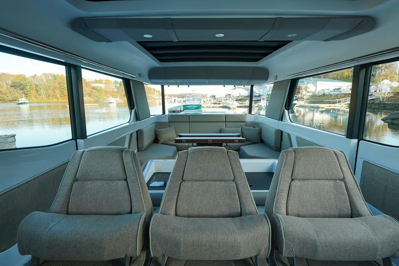 Slide: The Image of Luxurious interior of 2024 Axopar 45 boat with panoramic windows and plush seating. - 10