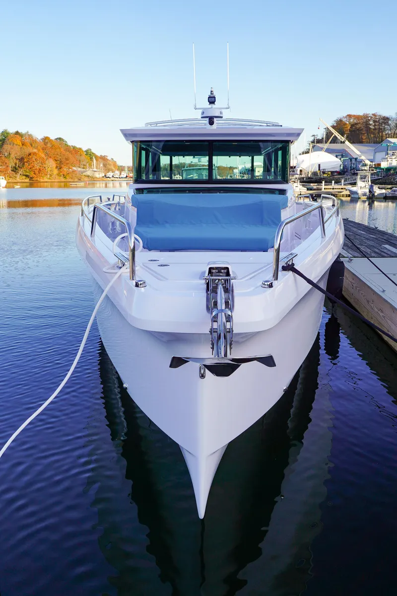 Slide: The Image of 2024 Axopar 45 boat docked in a serene marina. - 4