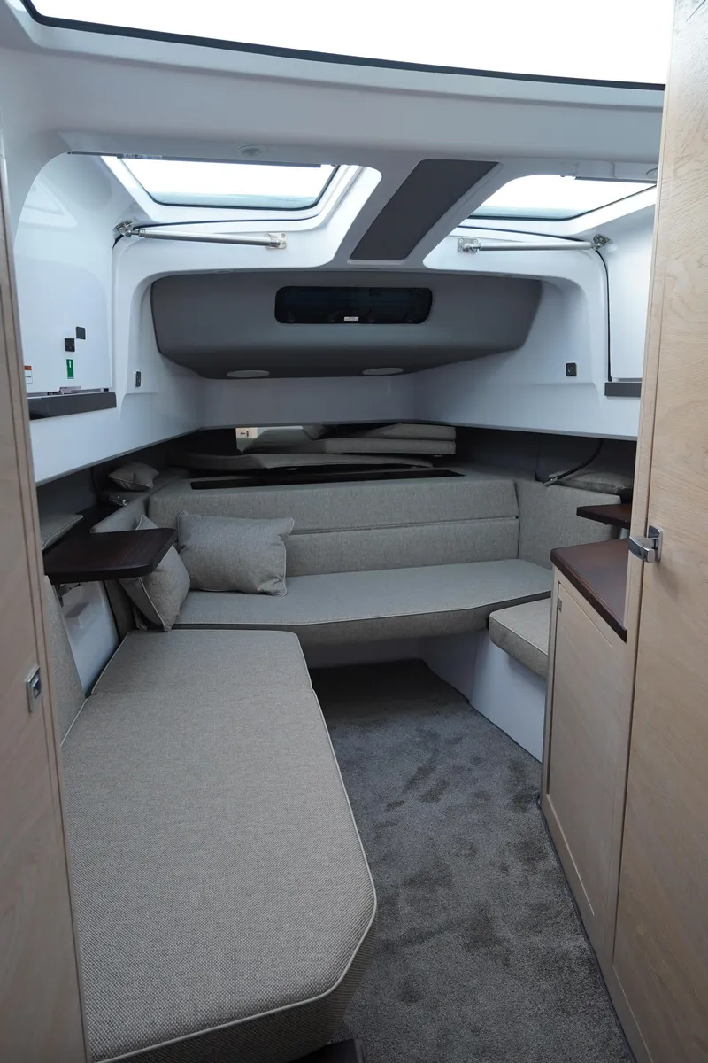 Slide: The Image of 2024 Axopar 45 boat interior with modern seating and skylights. - 5